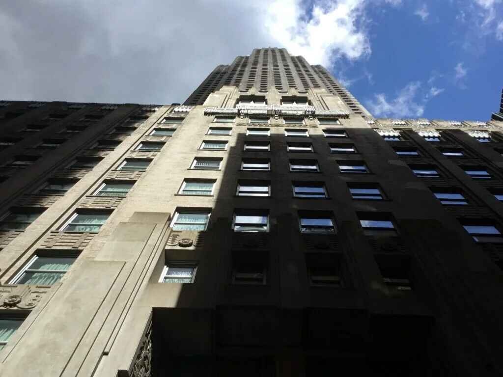 A close-up view of 70 pine street skyscraper in Lower Manhattan, showcasing its intricate architectural details.