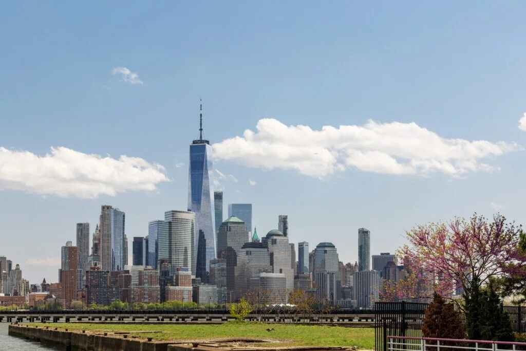 The Lower Manhattan skyline featuring the towering One World Trade Center and surrounding skyscrapers.