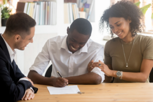 Young couple signing a lease for their new apartment